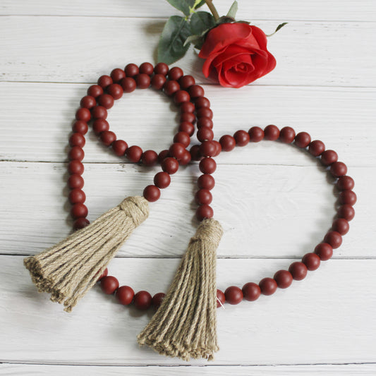 CVHOMEDECO. Wood Beads Garland with Tassels Farmhouse Rustic Wooden Prayer Bead String Wall Hanging Accent for Home Festival Decor. Burgundy