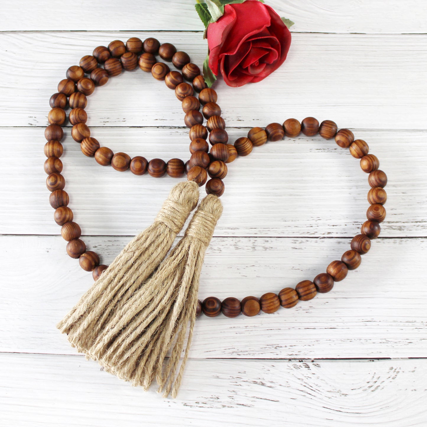 CVHOMEDECO. Wood Grain Beads Garland with Tassels Farmhouse Rustic Wooden Prayer Bead String Wall Hanging Accent for Home Festival Decor. Dark Brown
