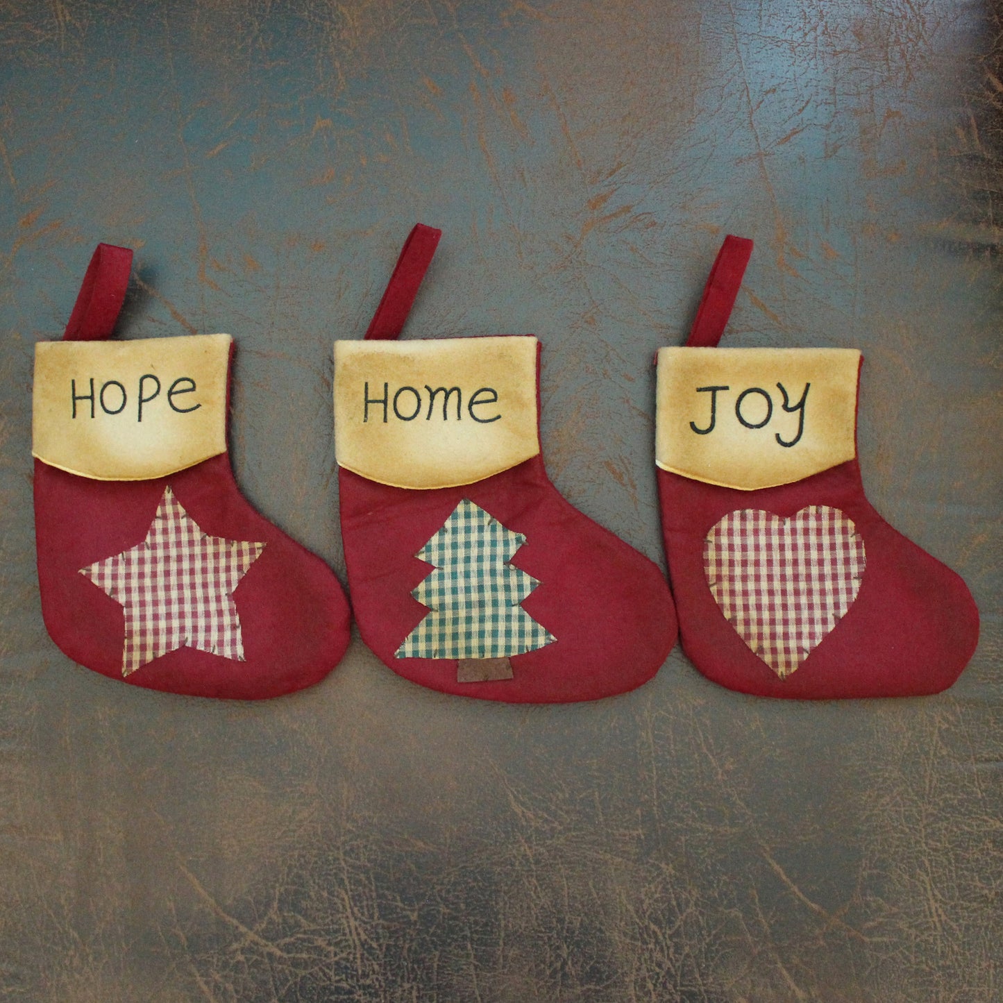 CVHOMEDECO. Primitive Vintage Design 7.5 Inch Christmas Tree Hanging Stockings with Stitched Messages Hope Home Joy Xmas Hanging Decoration Gifts, 3 Assorted.