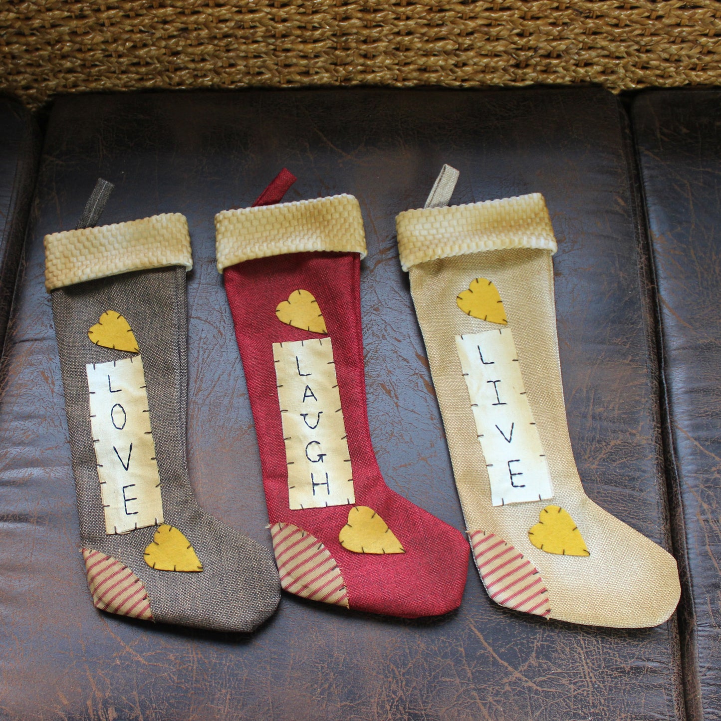 CVHOMEDECO. Primitive Rustic 16 Inch Hanging Stockings with Stitched Messages Live Laugh Love for Christmas or Home Décor. 3 Assorted