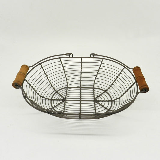 CVHOMEDECO. Oval Metal Wire Egg Basket Wire Basket with Wooden Handle Country Vintage Style Storage Basket. Rusty, 12.75 X 9 X 3.5 Inch